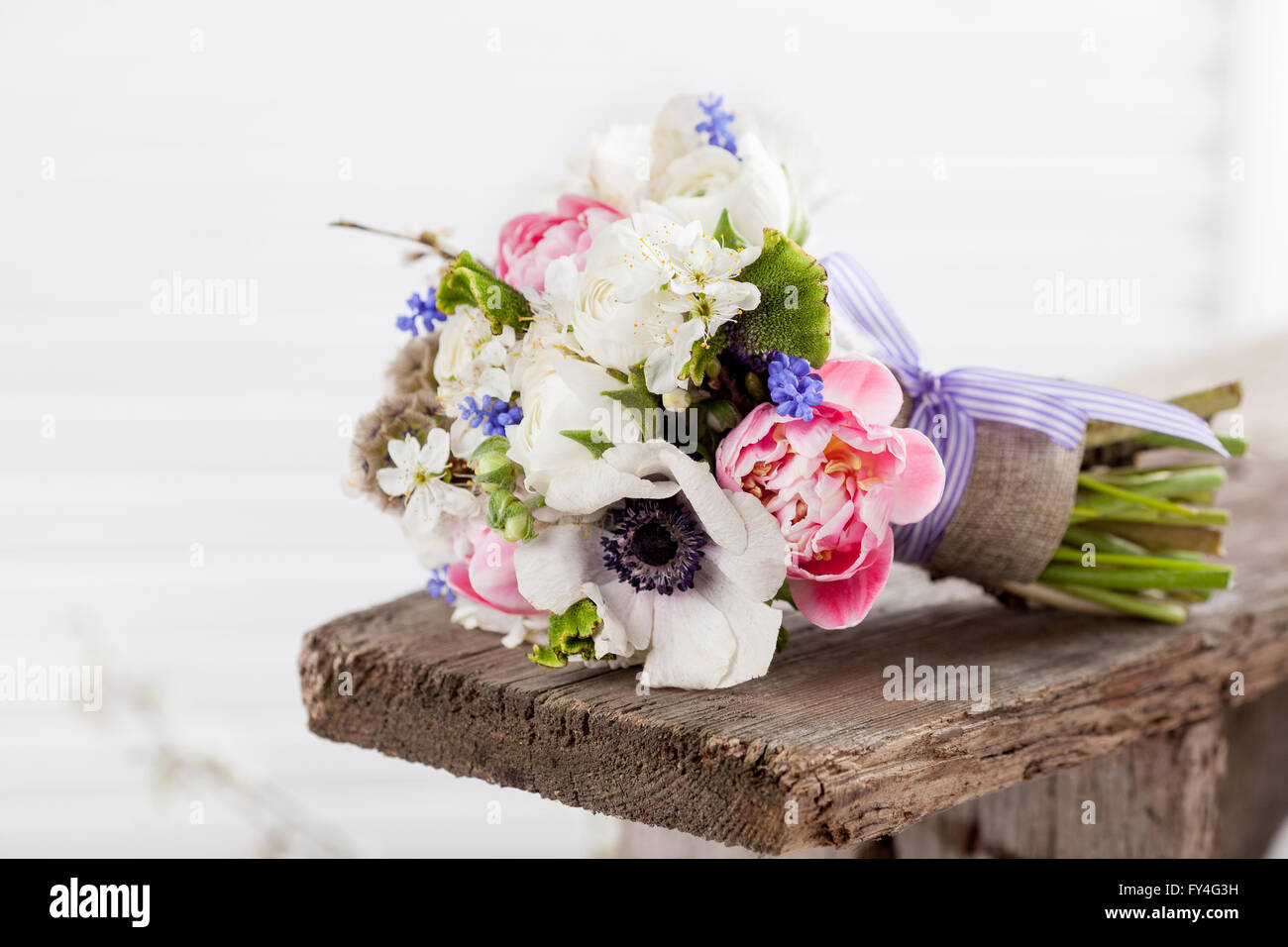 Bouquet from pink tulips, violet grape hyacinths, white anemones, violet veronica and white buttercup Stock Photo