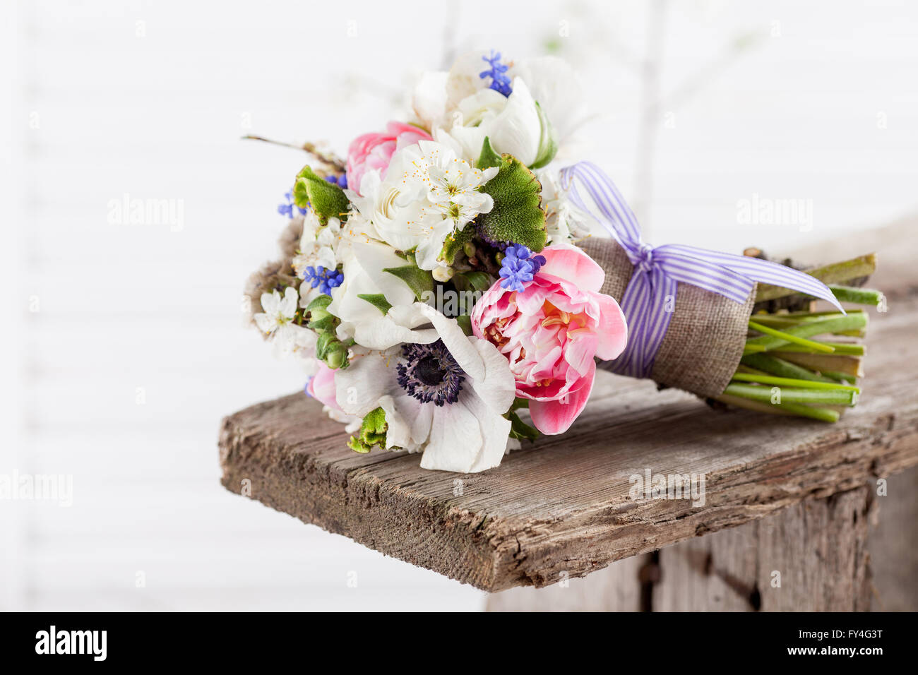 Bouquet from pink tulips, violet grape hyacinths, white anemones, violet veronica and white buttercups Stock Photo