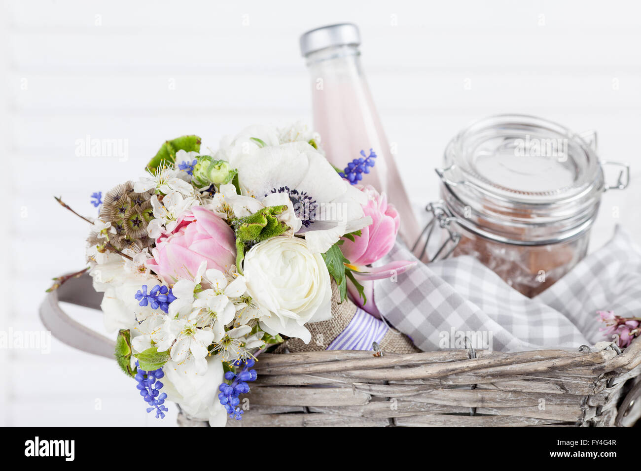Bouquet from white anemones in picnic basket Stock Photo