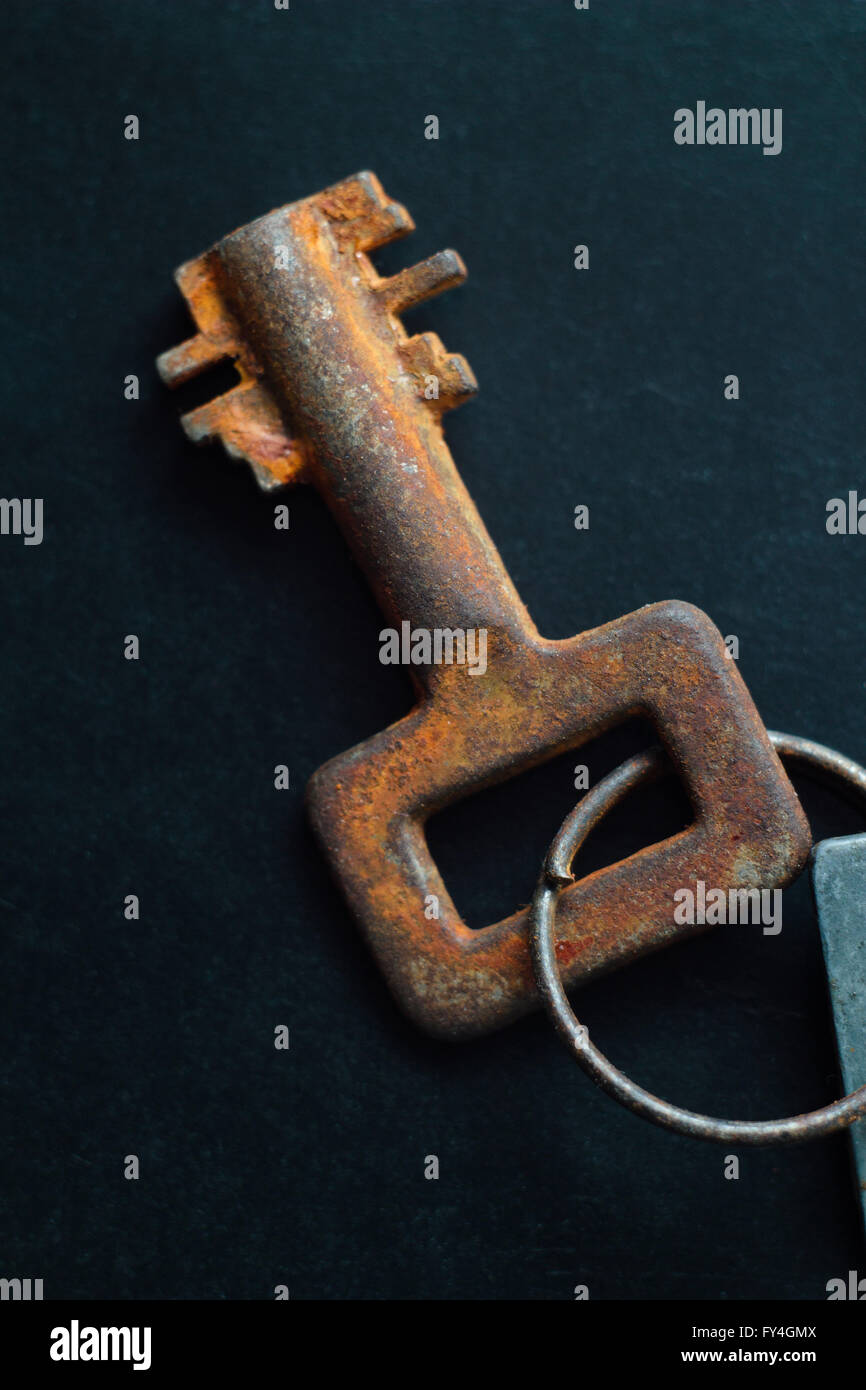 Old rusty key on dark background Stock Photo - Alamy