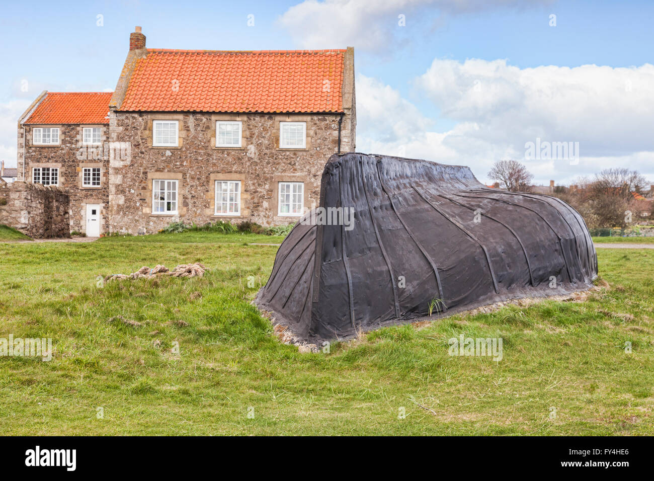 Upside down boat used as a shed, Lindisfarne, Northumberland, England, UK Stock Photo