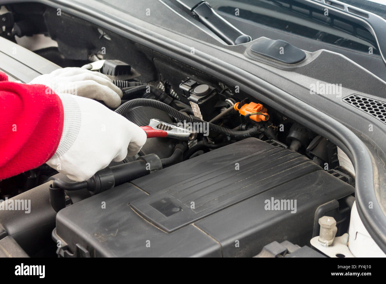 Mechanician performing maintenance on a car engine Stock Photo - Alamy