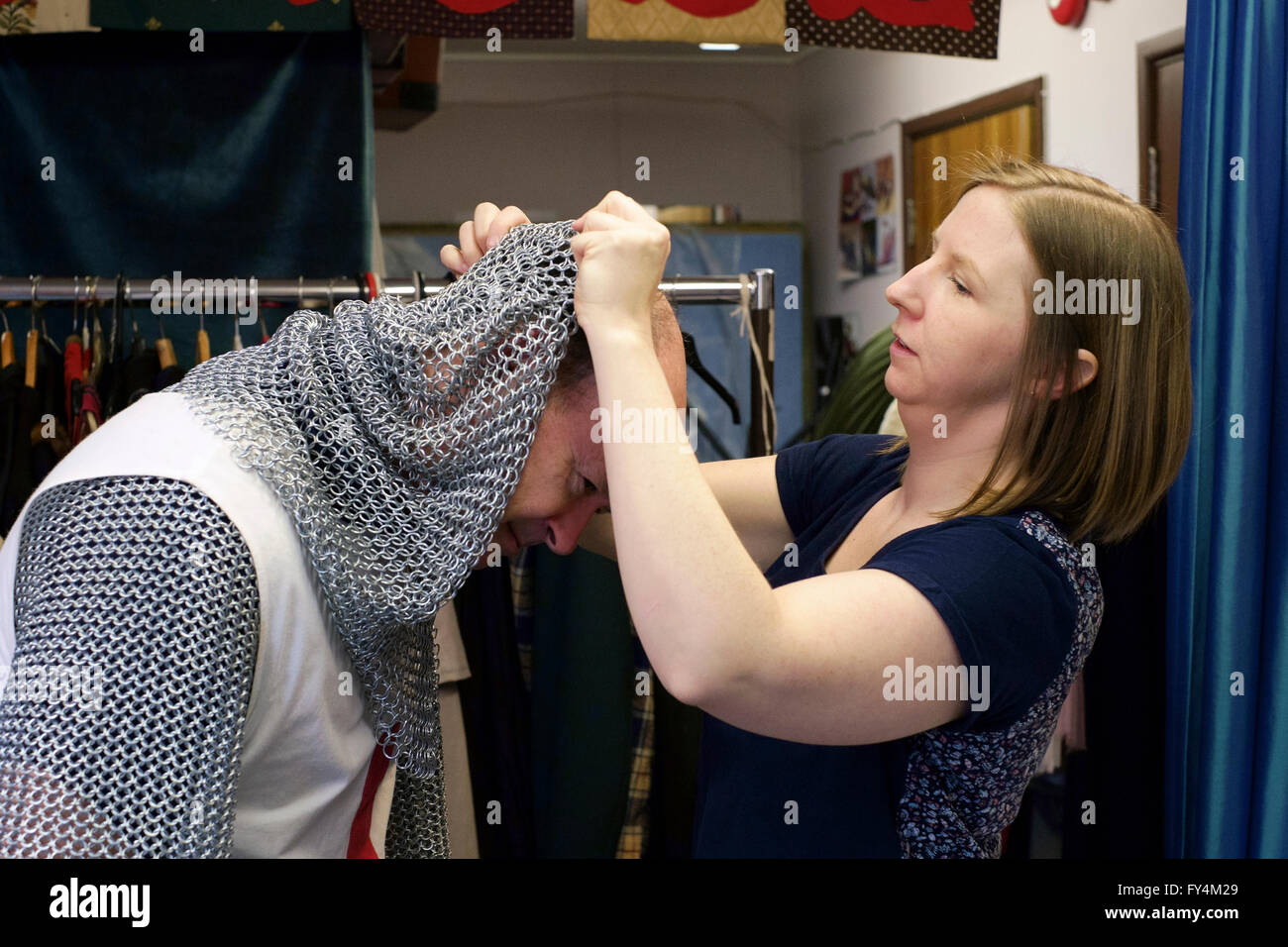 man trying on st outfit at fancy dress hire outlet in england uk