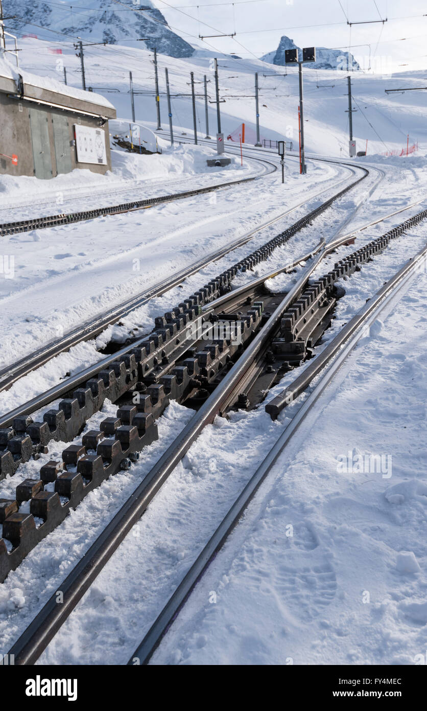 Snow-covered rails of the Gornergrat railway at Riffelberg station ...