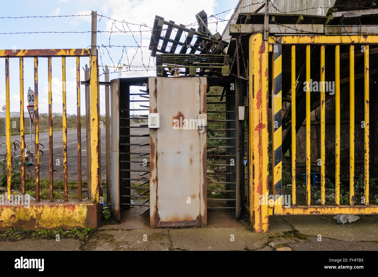 Turnstiles at the entrance of a closed-down factory. Stock Photo