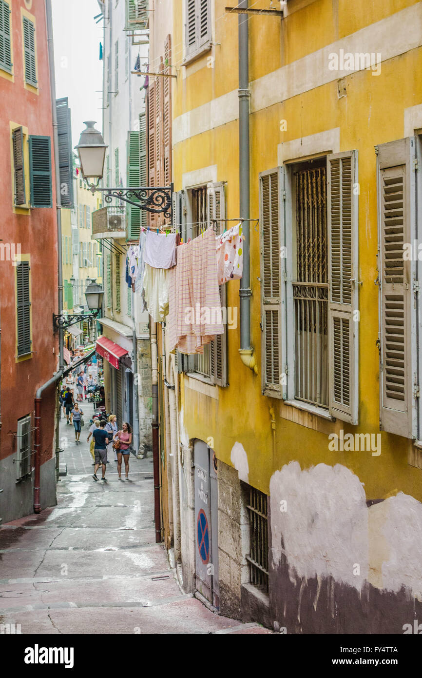France, Nice, narrow alley in the Old Town next to the main tourist thoroughfare, drying the laundry Stock Photo