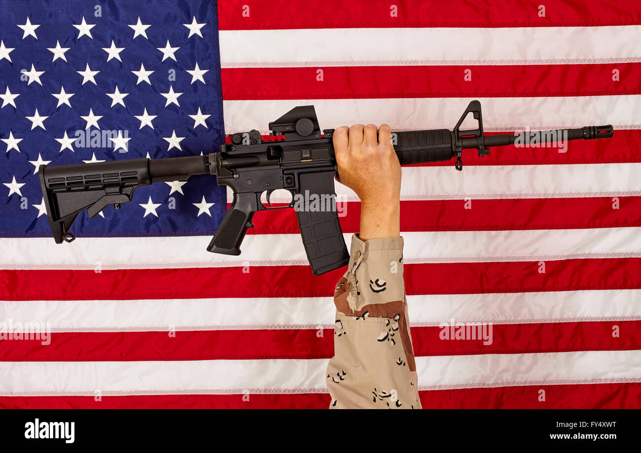 AR15 M4A1 Soldier Man with  M16 Style Weapon Automatic Rifle on USA Flag concept freedom patriotism veteran Stock Photo