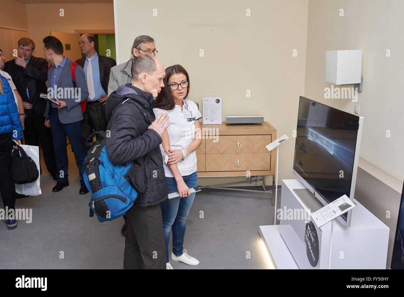 Moscow Hi Fi and High End Show, Moscow, Russia - April 15, 2016: Loewe german company representative shows brand new TV-set. Stock Photo