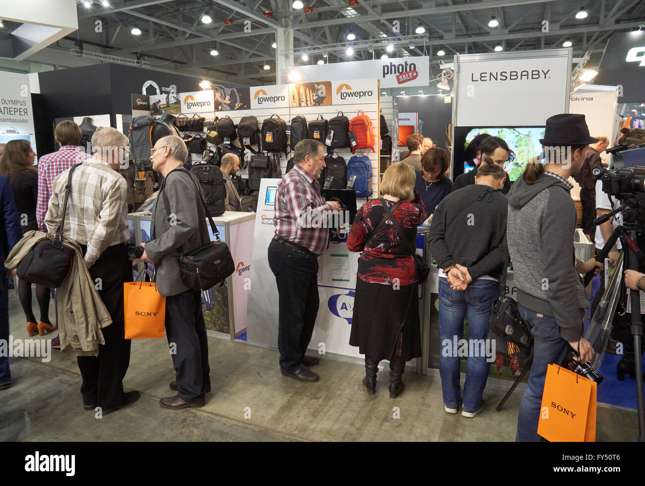 Moscow Crocus Expo, Moscow, Russia - April 15, 2016: Visitors trying bags at Photo Sale stand at Photoforum 2016 Stock Photo