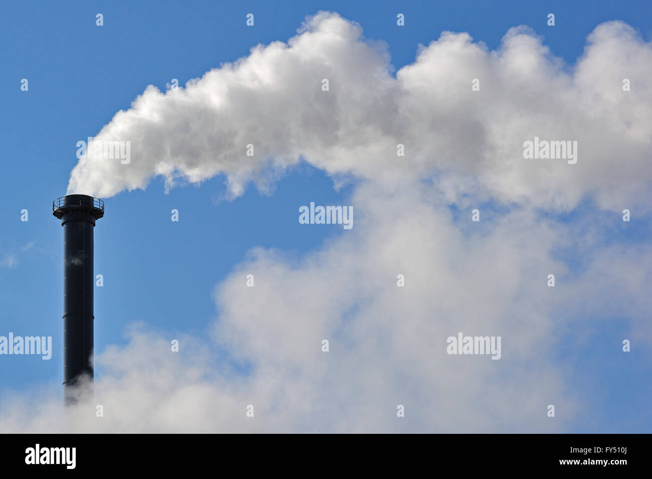 Conceptual image showing air pollution from industry showing chimney issuing fume into the atmosphere Stock Photo