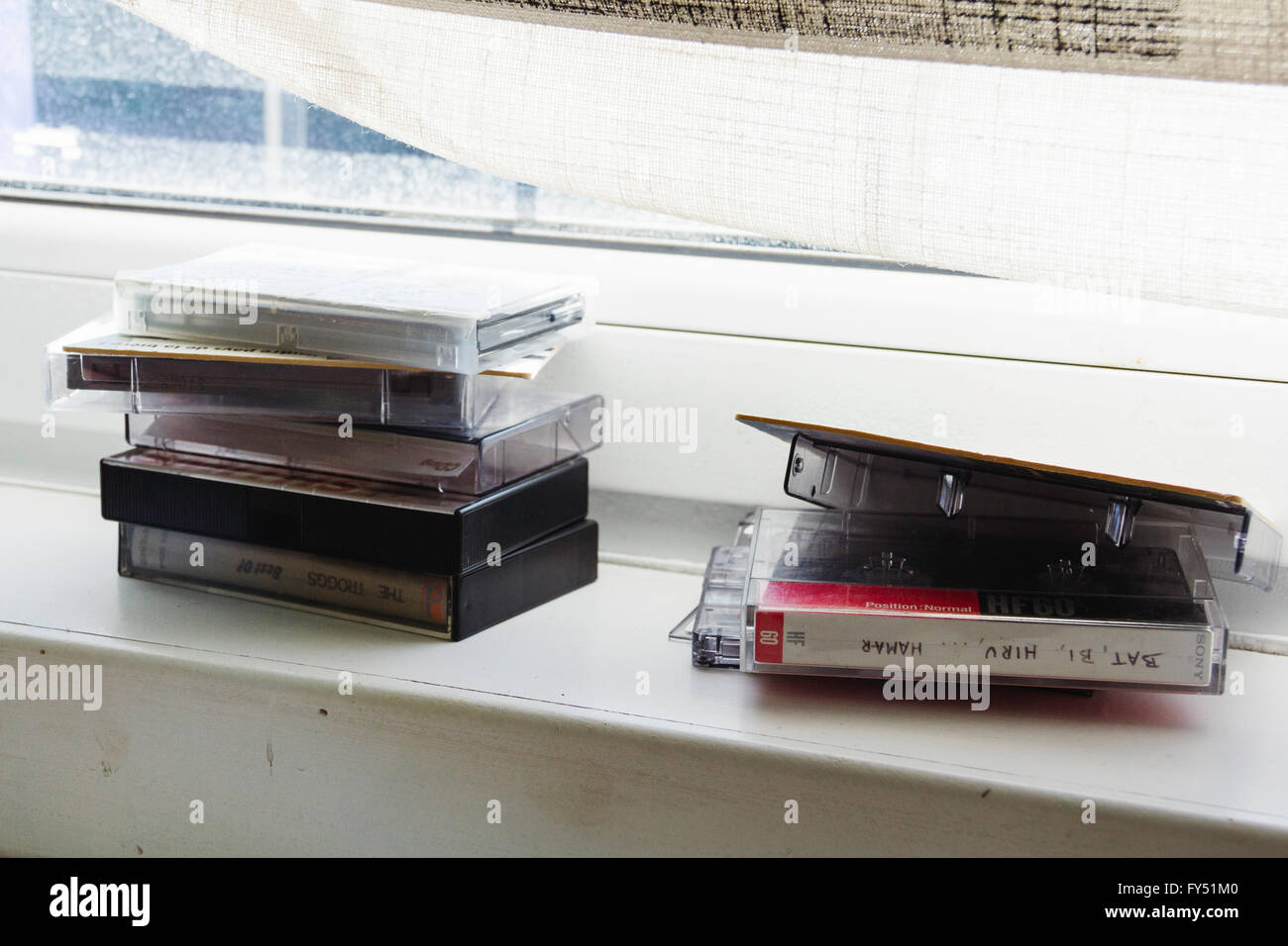 Two piles of audio tapes on a window sill. Stock Photo