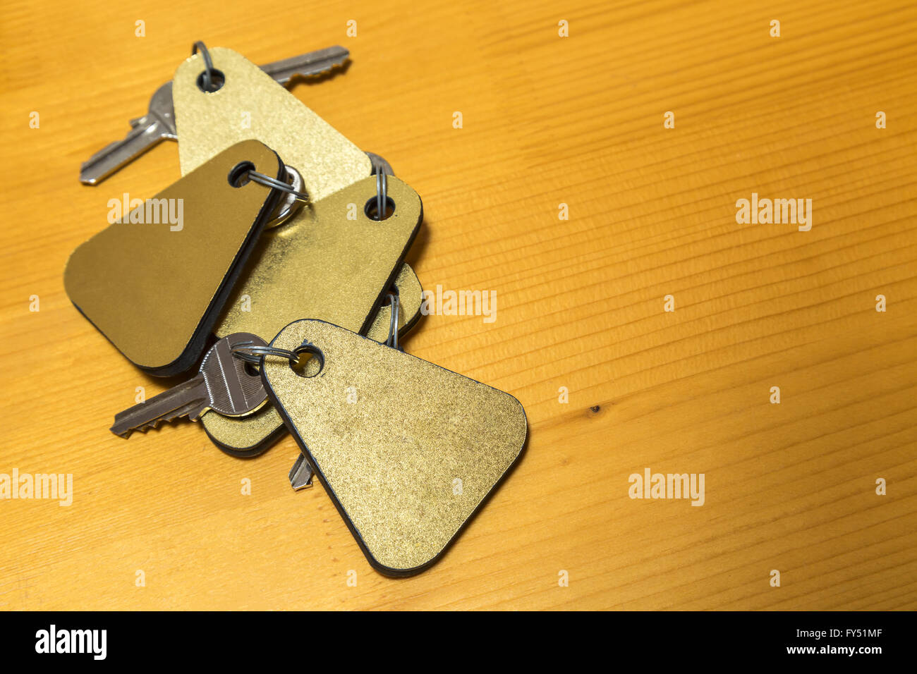 Heap of hotel room keys on a wooden table Stock Photo Alamy