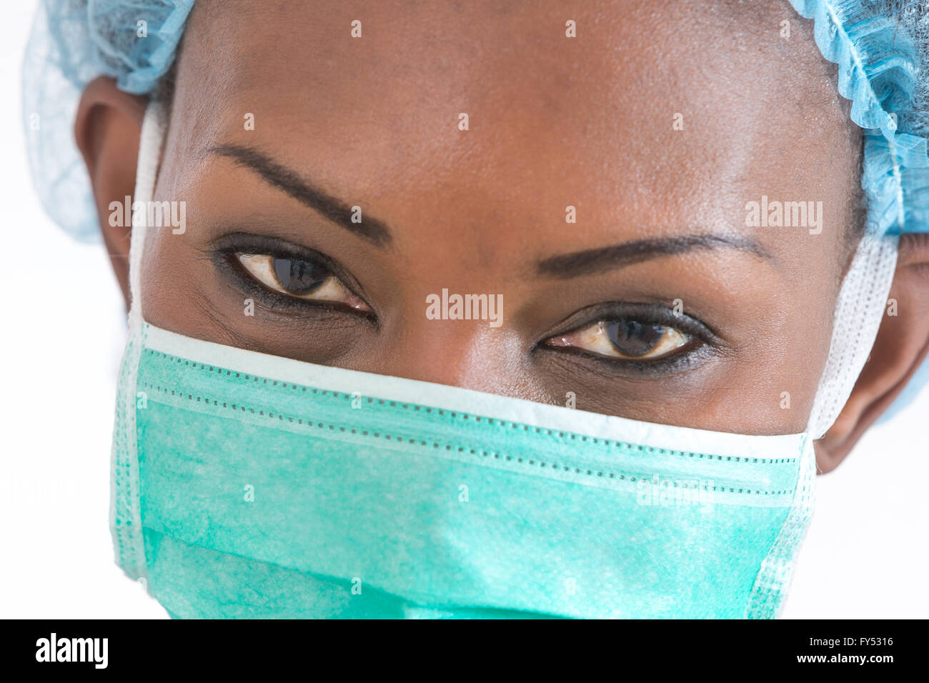 Smiling African American nurse at hospital work station on white