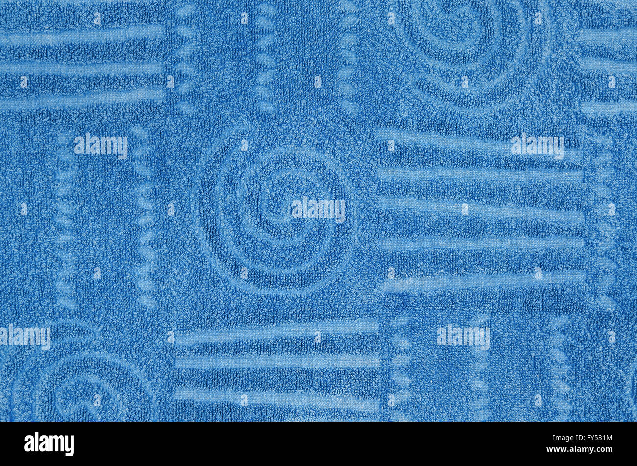close up of a cyan, blue, terry towel with geometrical and spiral pattern,  horizontal Stock Photo