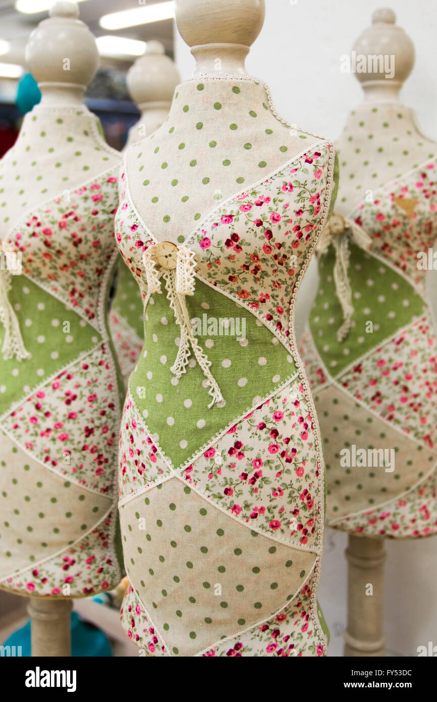 Tailoring mannequins covered with colored cloth in a clothing store