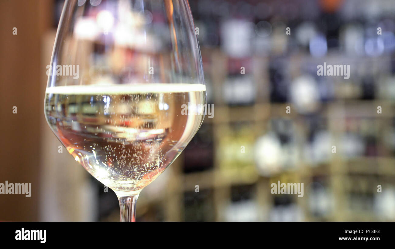 A fizzy wine glass on the bar counter. Stock Photo