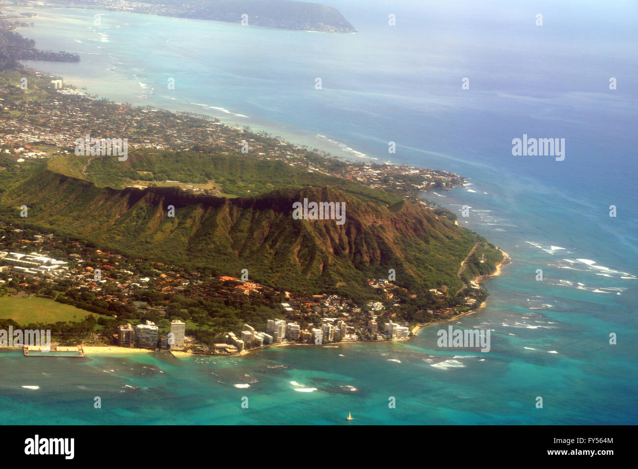 Aerial view of Diamond Head Crater, Kapiolani park, Black Point and Kahala on Oahu with wave braking against reef on nice day. Stock Photo