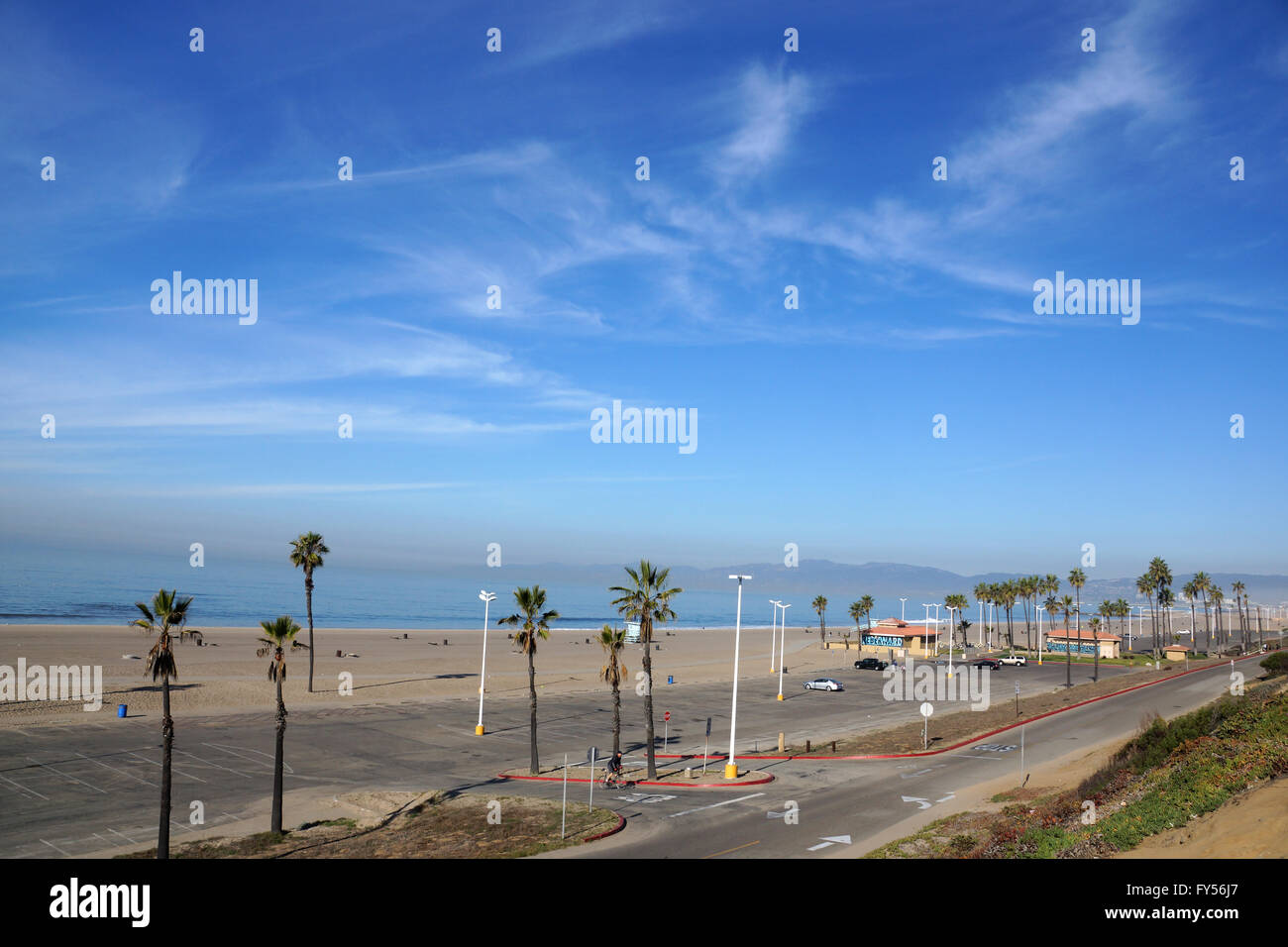 Beach, Pacific ocean, park, parking lot, and restroom buildings in the early morning at