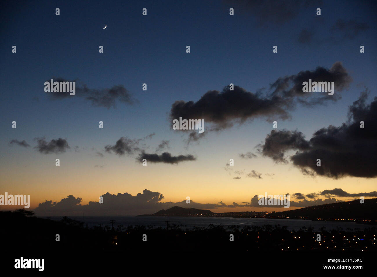 Hawaii Kai and Diamond Head at Night Fall on Oahu, Hawaii with moon sliver overhead. Stock Photo