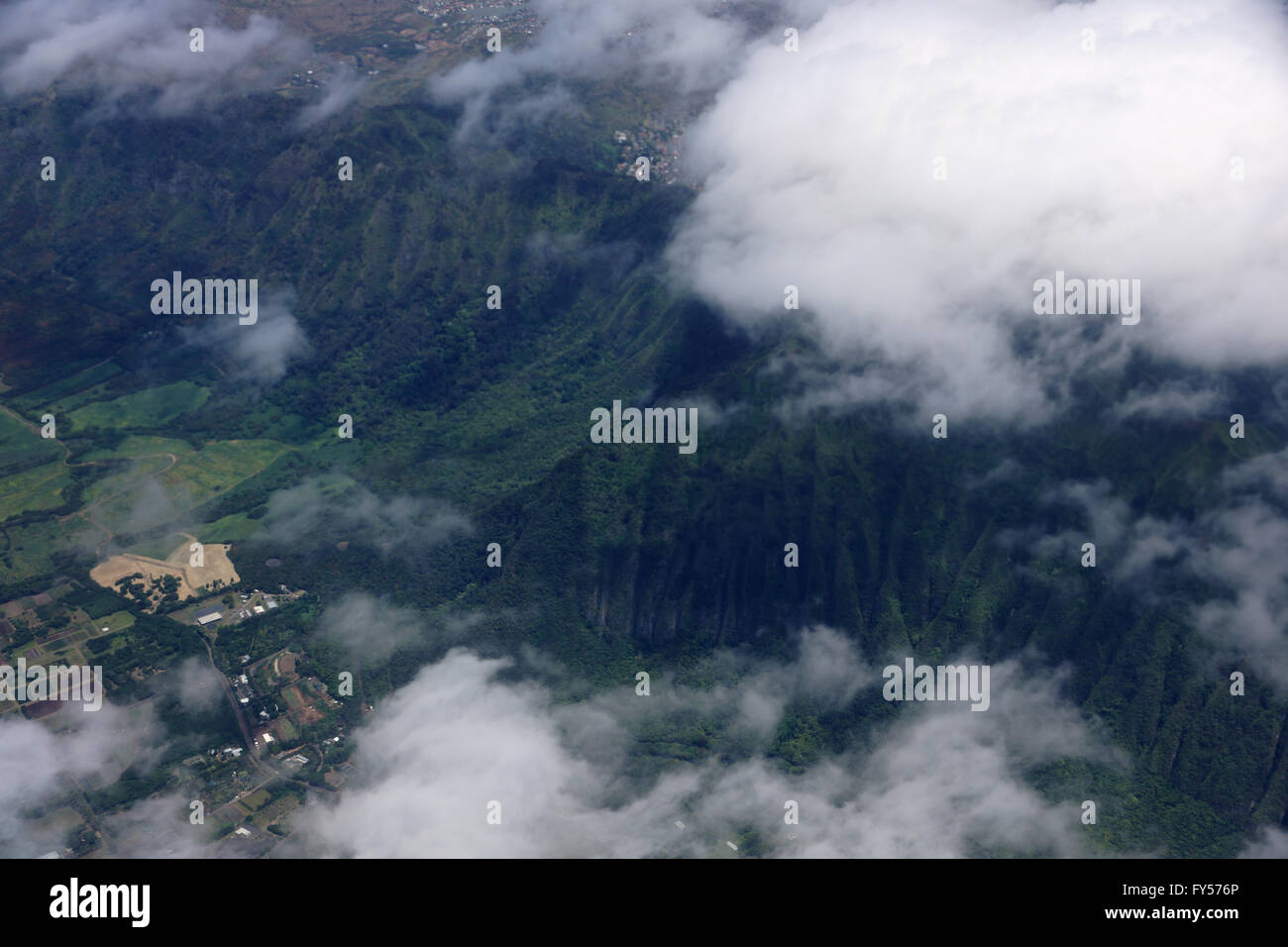 Aerial view of clouds over Waimanalo Farm lands, koolau mountains, and ridge communities of Honolulu on the island of Oahu in th Stock Photo