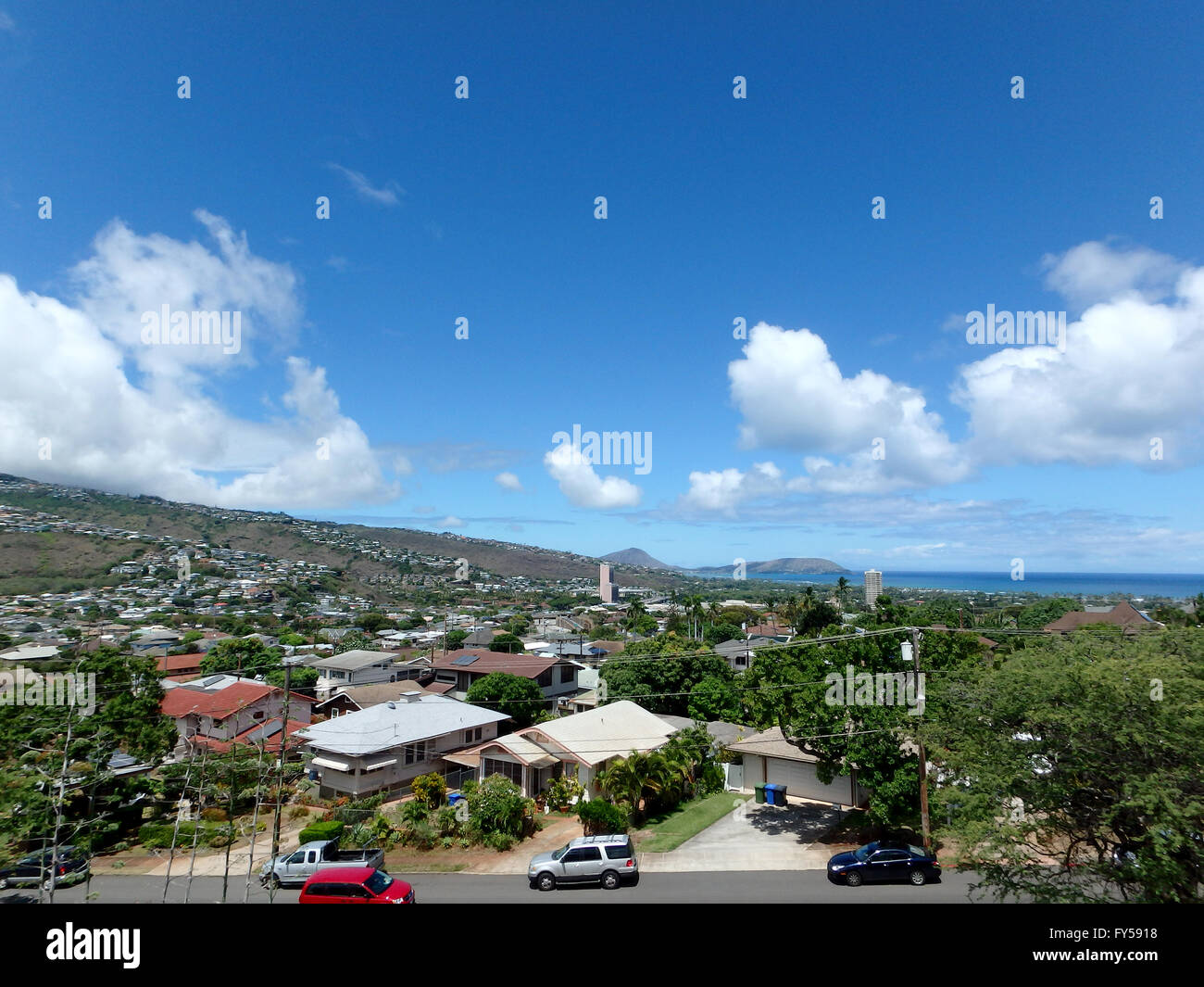 Kahala and South East corner of Oahu with Mountains, trees, houses, power lines and clouds in the sky. Stock Photo