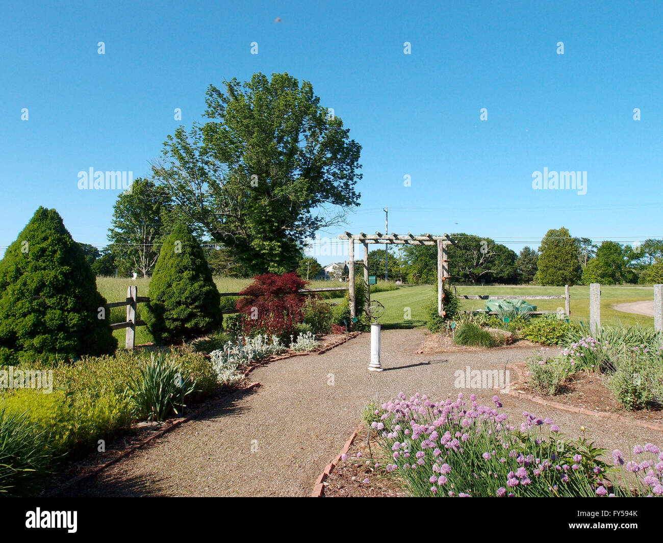 Path in Garden with orb statue in center and archway in Lebanon