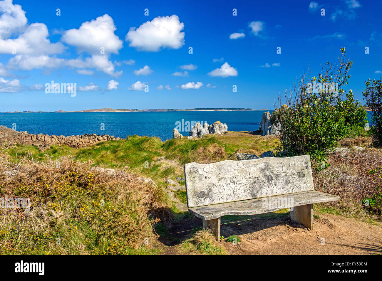 Carved Bench on St Agnes Isles of Scilly UK on a sunny blue sky day Stock Photo