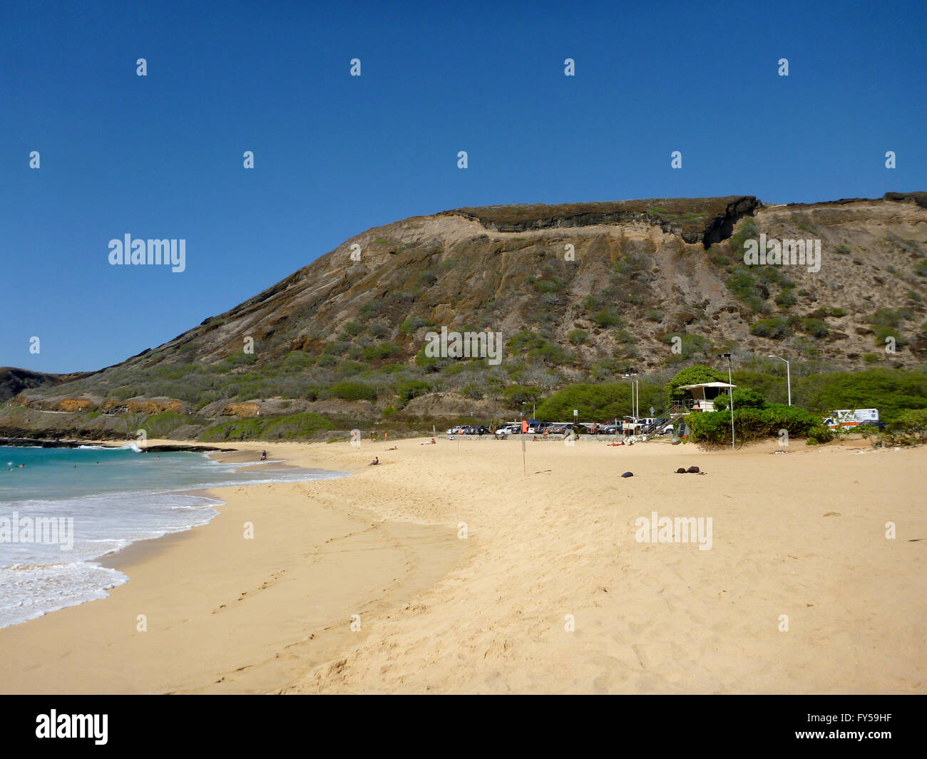 Waves Lap On Beach Of Sandy Beach Park With Koko Head Crater In The
