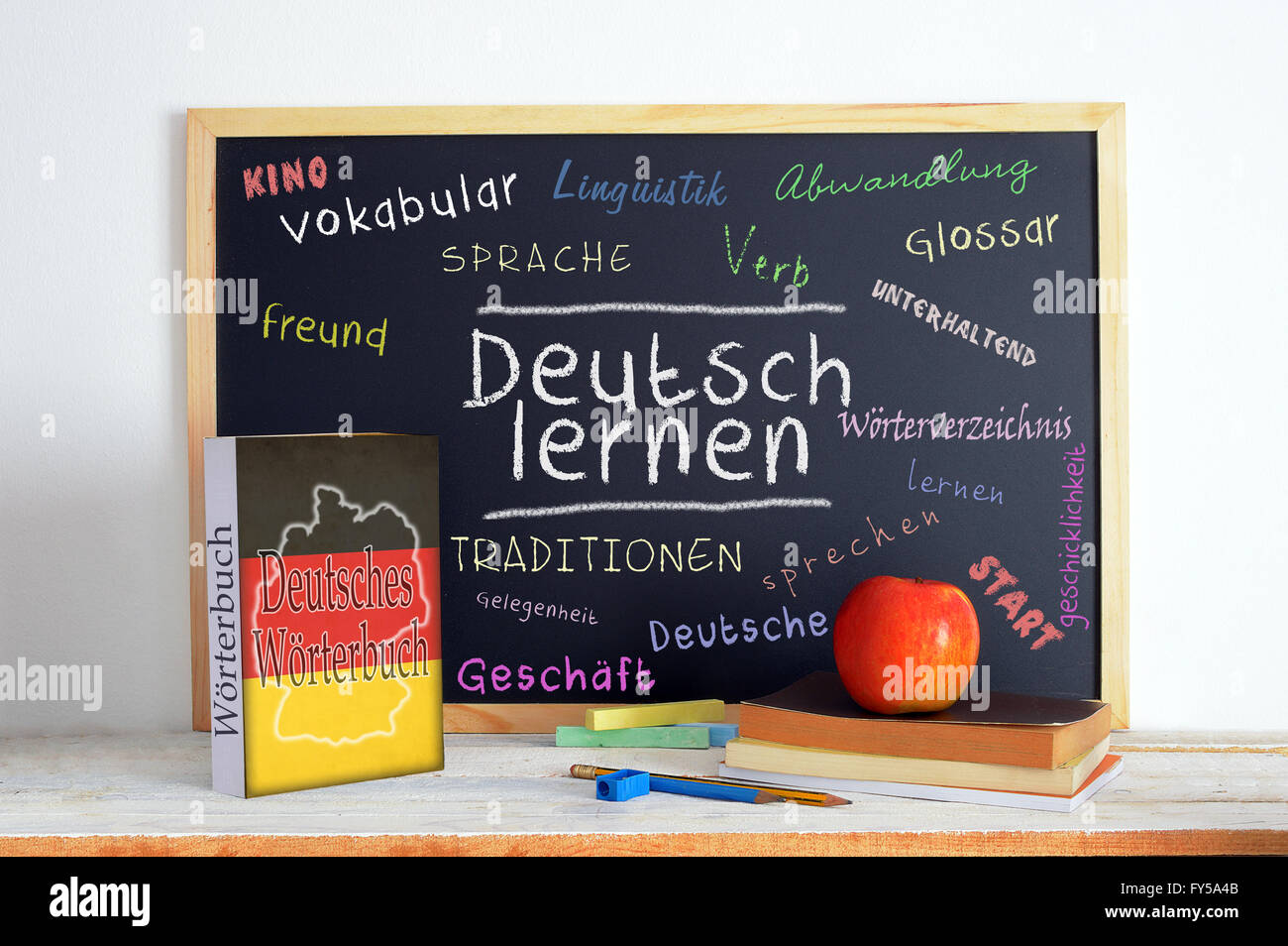 Blackboard in a German classroom with the message LEARN GERMAN and some text Stock Photo