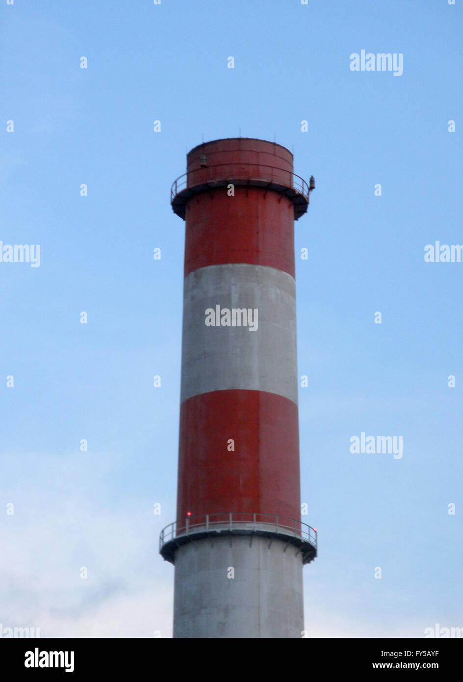 Vertical image of a smoke stack in Los Angeles with red and white strips. Stock Photo