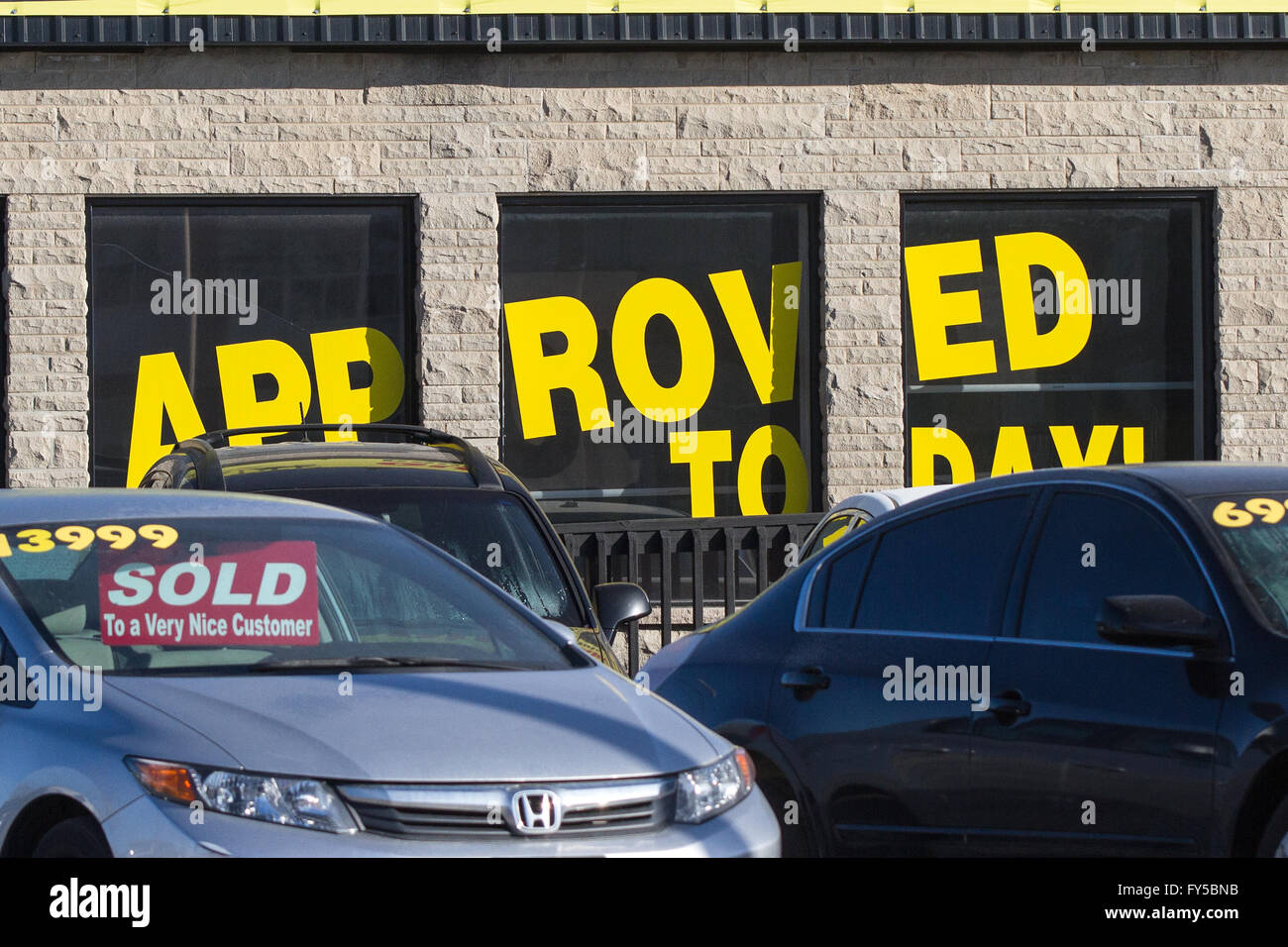 Several used cars for sale at a car dealership in Kingston, Ont., on