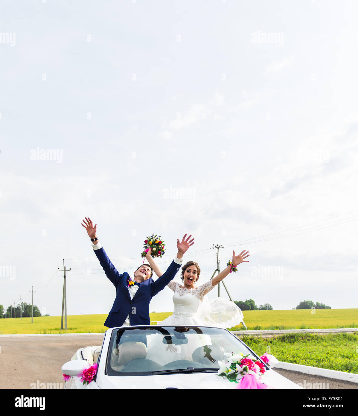 The groom and the bride in a white convertible car Stock Photo - Alamy