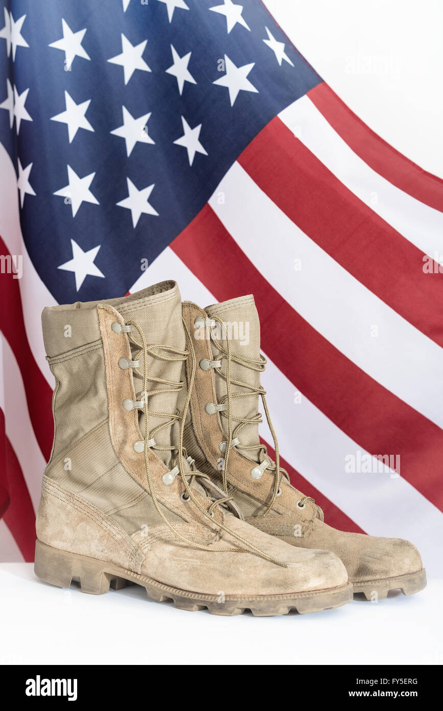 Old combat boots with American flag in the background Stock Photo - Alamy