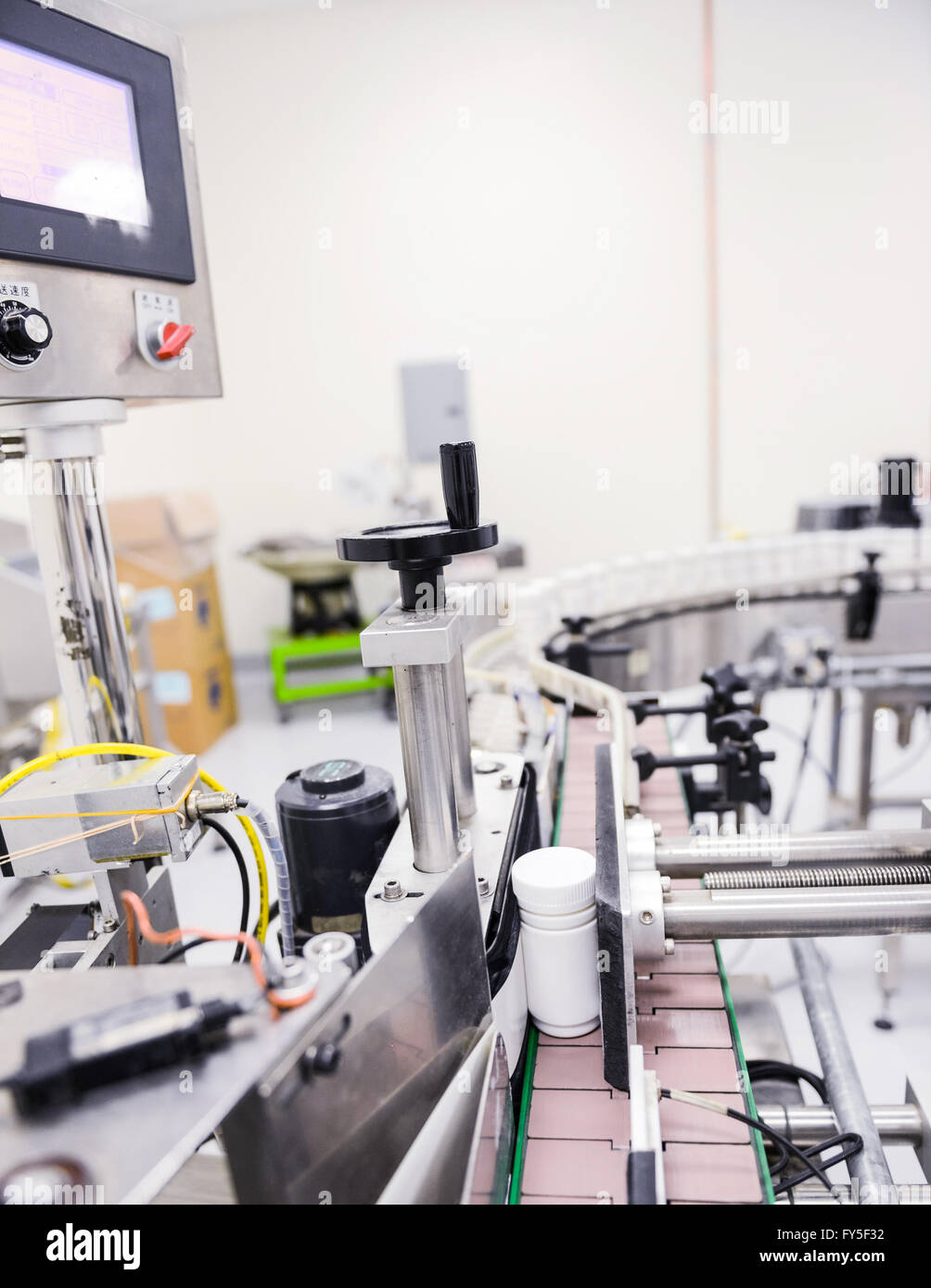Factory Machines and Bottle Processing Stock Photo