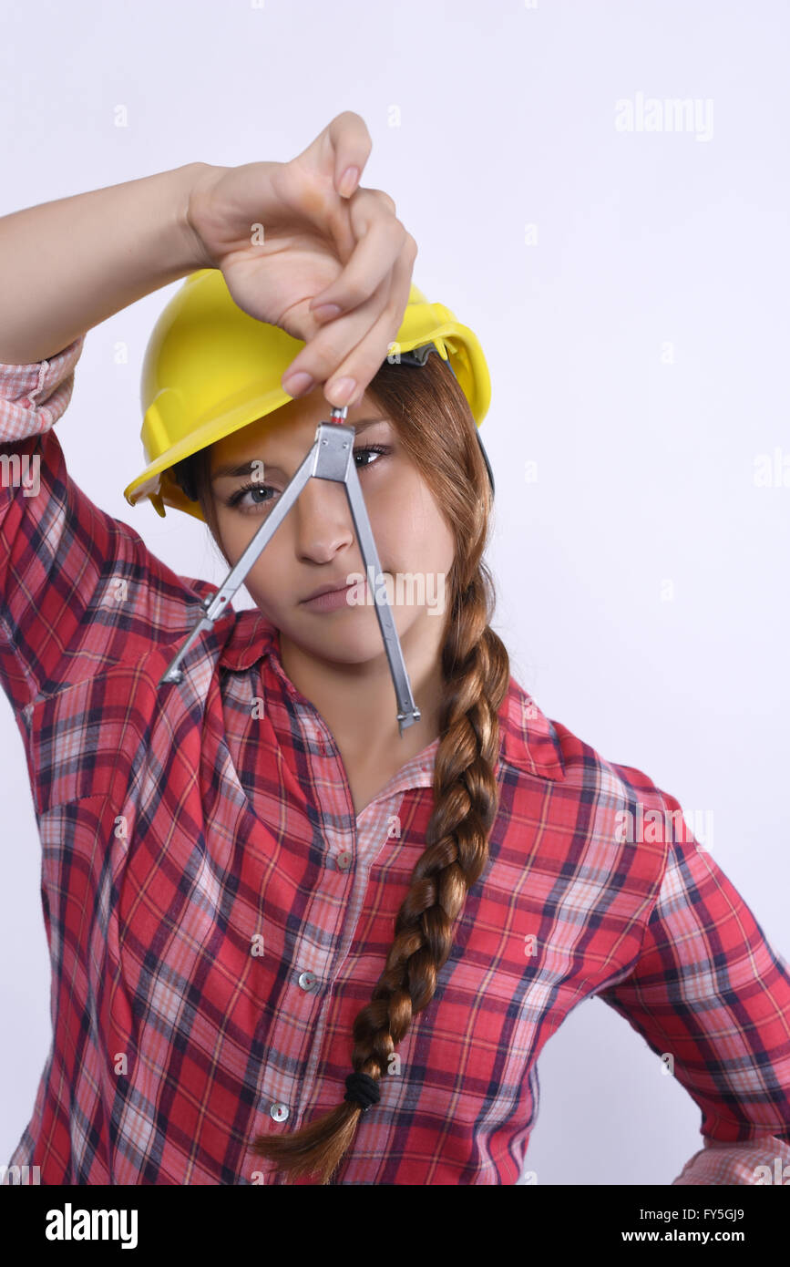 Portrait of beautiful woman construction worker with compass. Isolated white background. Stock Photo