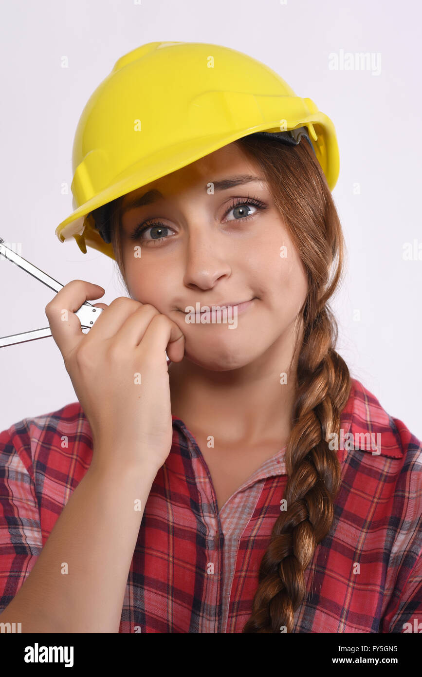 Portrait of beautiful woman construction worker with compass and construction helmet. Isolated white background. Stock Photo