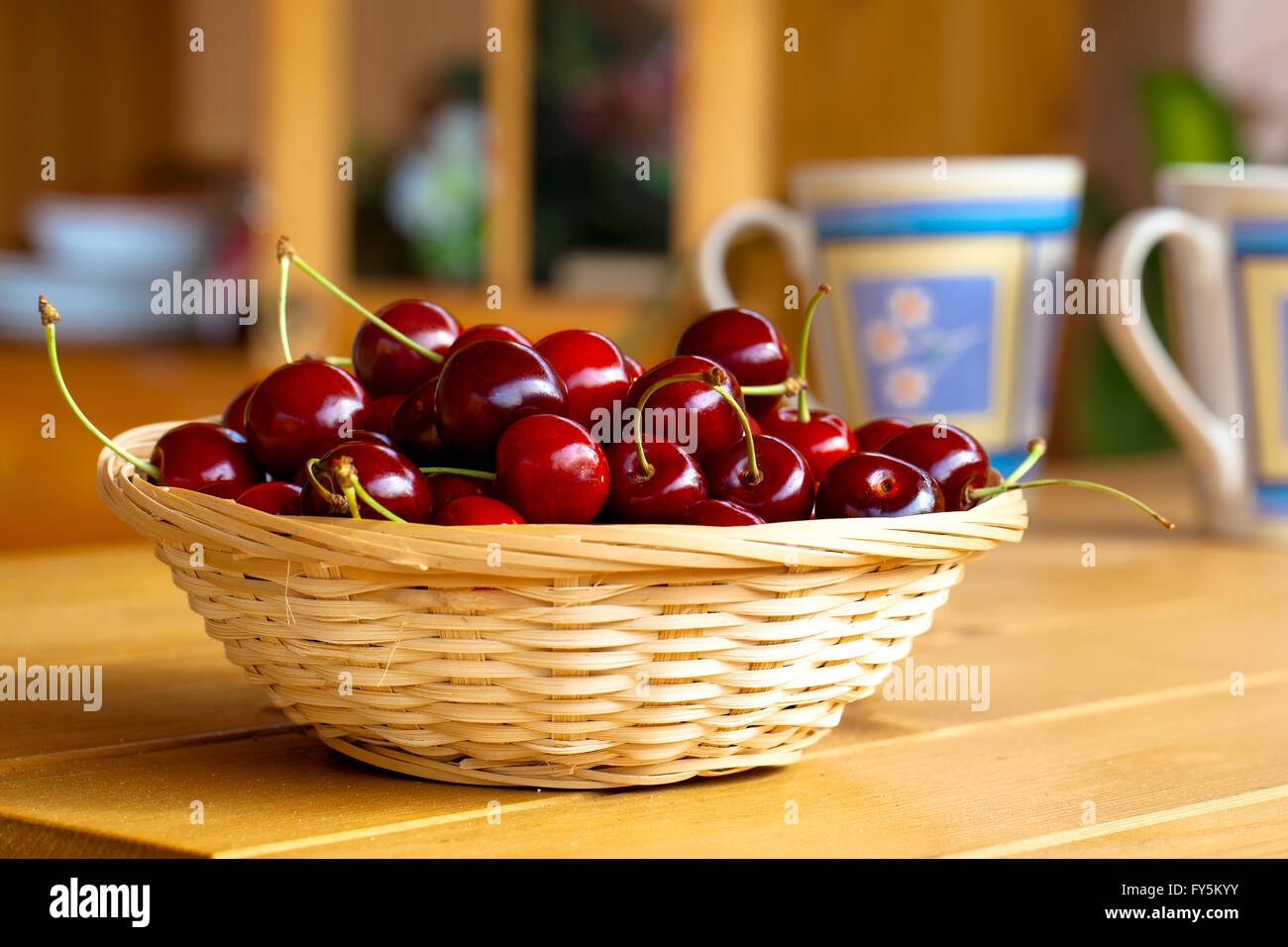 wicker basket with fresh sweet cherries Stock Photo