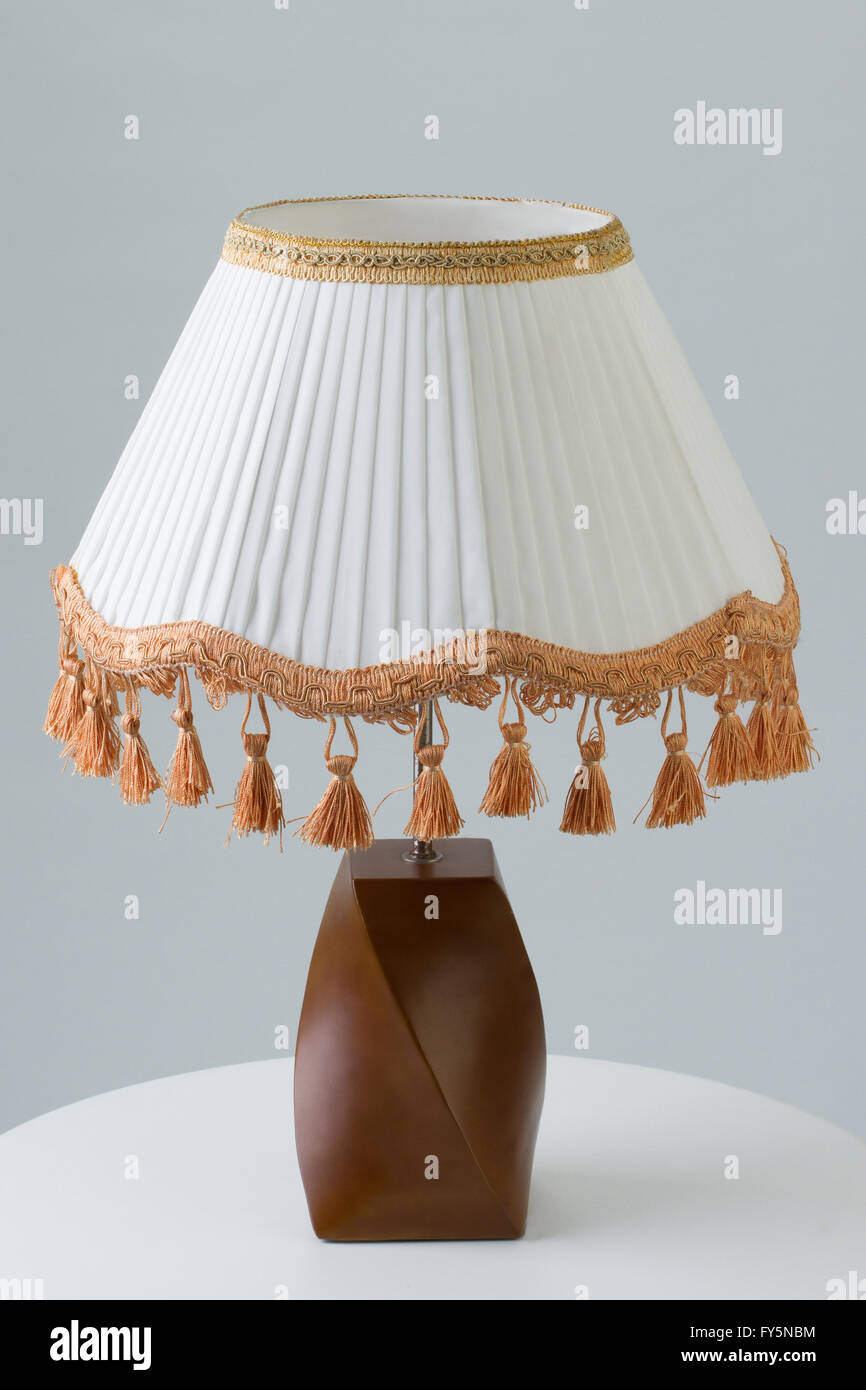Luxury table lamp on white table against gray background Stock Photo