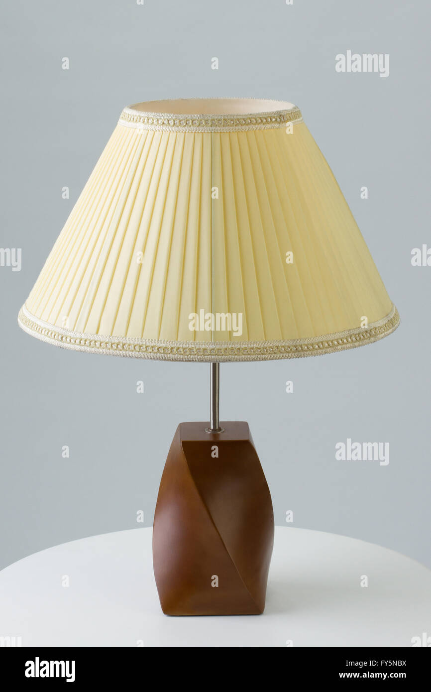 Table lamp on white table on gray background Stock Photo