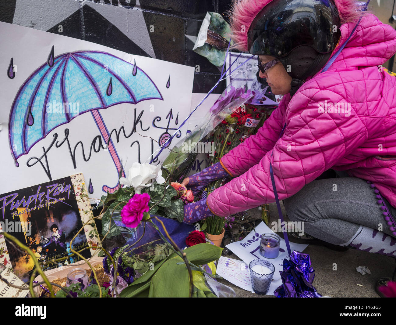 Minneapolis, MN, USA. 22nd Apr, 2016. MINA LEIERWOOD, from Minneapolis, MN, leaves a thank you card at a memorial for Prince in front of 1st Ave in Minneapolis. She said listened to Prince's music all through high school. Thousands of people came to 1st Ave in Minneapolis Friday to mourn the death of Prince, whose full name is Prince Rogers Nelson. 1st Ave is the nightclub the musical icon made famous in his semi autobiographical movie ''Purple Rain.'' Prince, 57 years old, died Thursday, April 21, 2016, at Paisley Park, his home, office and recording complex in Chanhassen, MN. (Cr Stock Photo