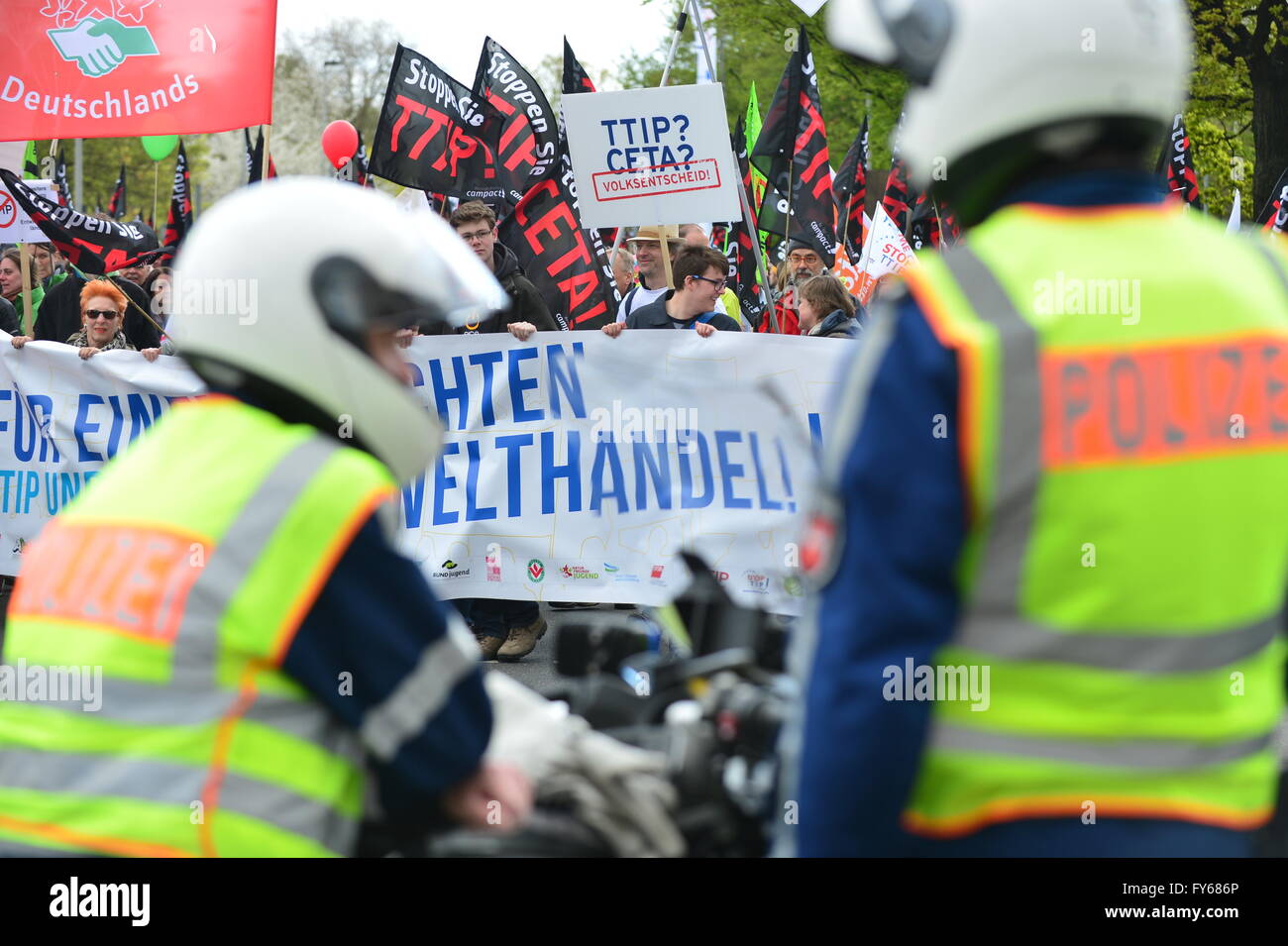 Hanover, Germany. 23rd Apr, 2016. Policemen securing a demonstration against the controversial transatlantic trade agreement TTIP in Hanover, Germany, 23 April 2016. Organisations for environment and consumer protection as well as for third world relief fear sinking ecological and social standards in Europe and that the agreement gives more power to big corportations. US-President Obama visits the Hanover Messe fair from 24 to 25 April 2016 in Hanover. PHOTO: HAUKE-CHRISTIAN DITTRICH/dpa/Alamy Live News Stock Photo