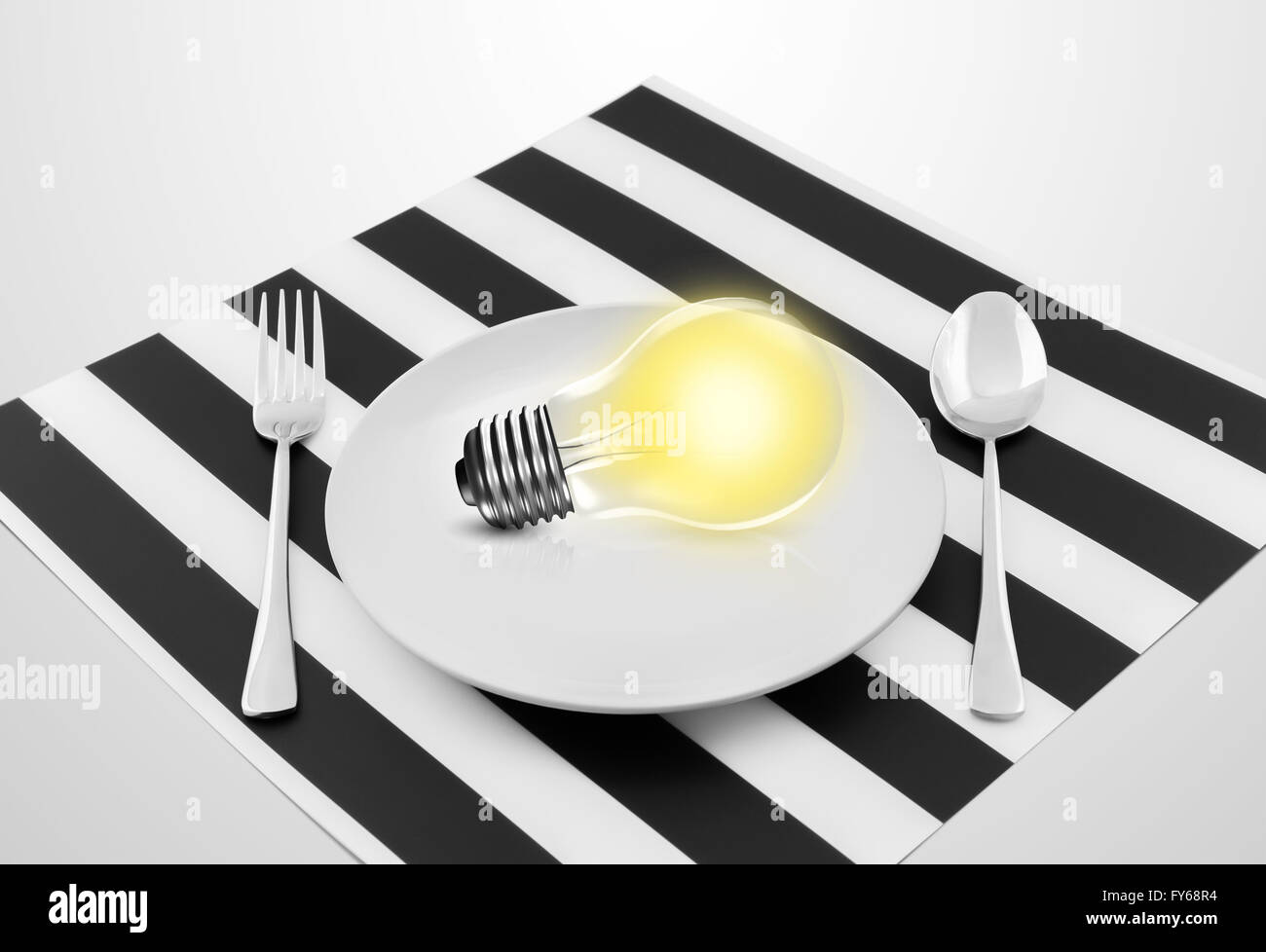 Lamp in plate and fork and spoon, Serving an idea concept Stock Photo