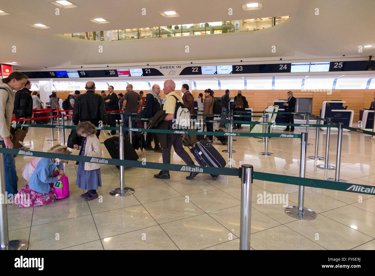 Departing passengers queue in departures check-in hall for check in Naples (Capodichino) International Airport (NAP). Italy. Stock Photo