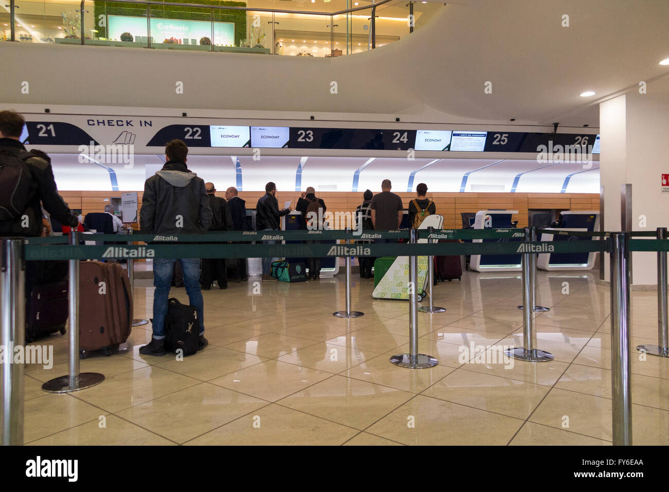 Departing passengers queue in departures check-in hall for check in Naples (Capodichino) International Airport (NAP). Italy. Stock Photo