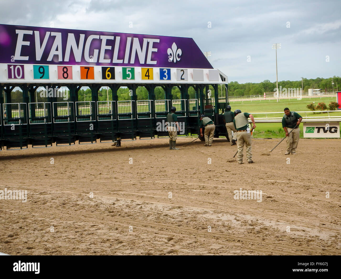 Backstretch workers preparing gate at Evangeline Downs race track. Stock Photo