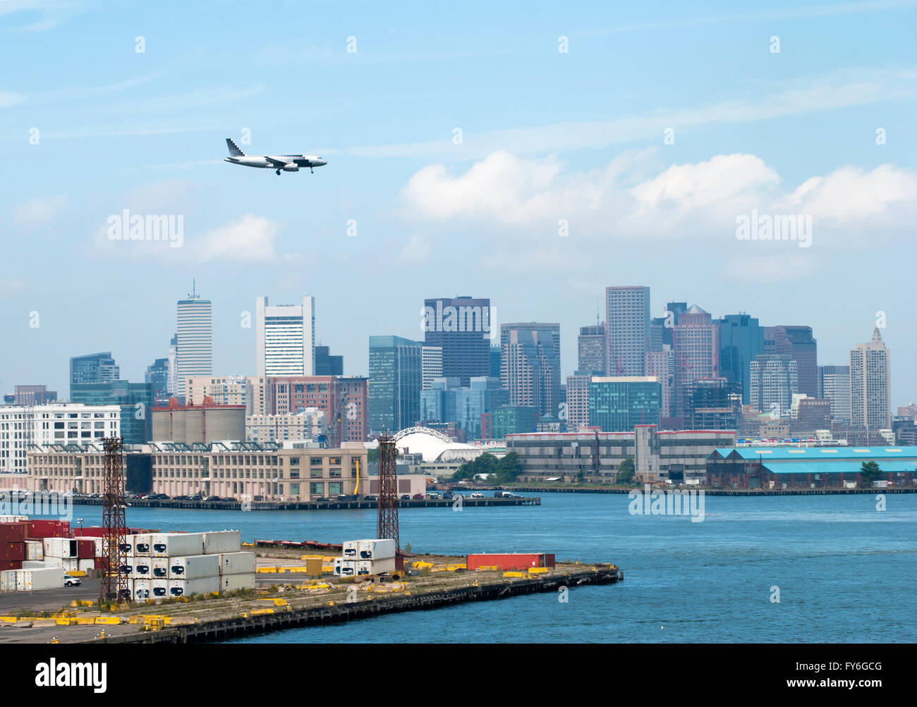 The passenger plane is flying over Boston downtown (Massachusetts Stock