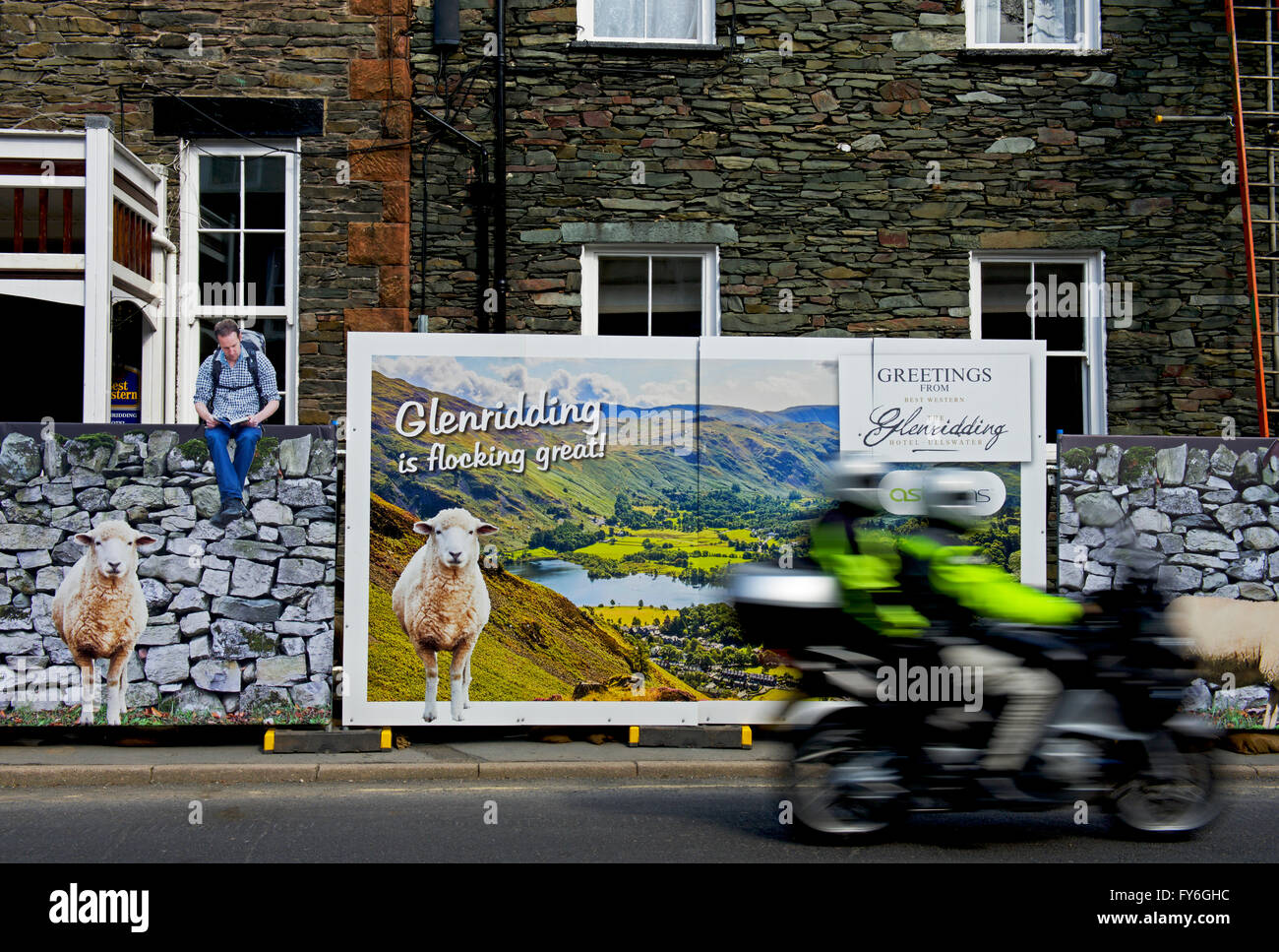 Motorbike passing sign erected in front of the Glenridding Hotel, Glenridding, Lake District National Park, Cumbria, England UK Stock Photo