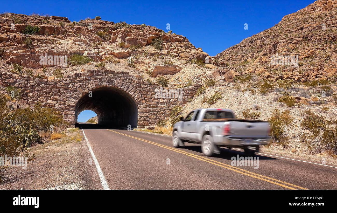 Car drives through a stone tunnel in Big Bend National Park, Texas Stock Photo