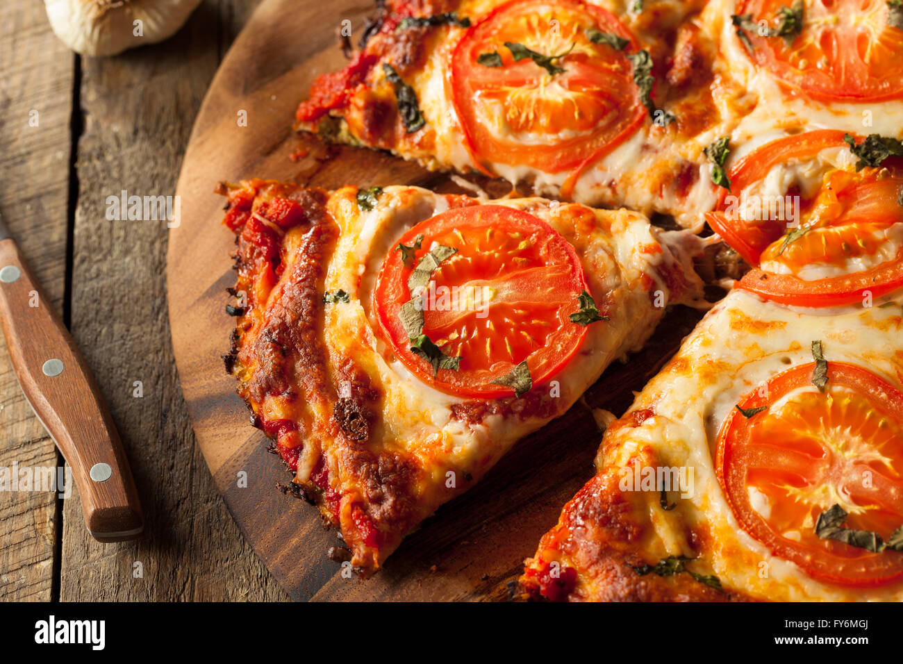 Homemade Vegan Cauliflower Crust Pizza with Tomato and Basil Stock Photo