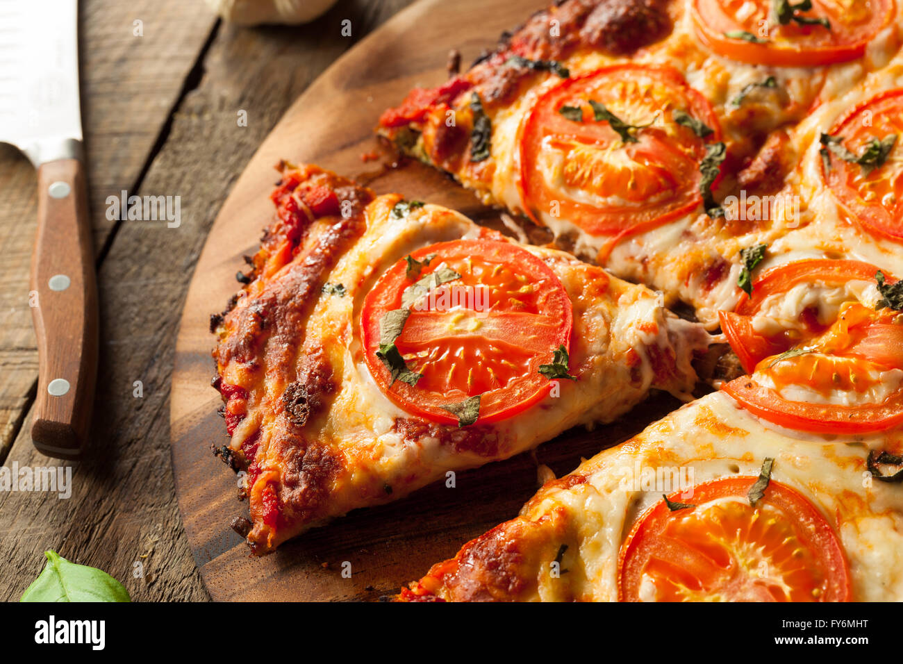 Homemade Vegan Cauliflower Crust Pizza with Tomato and Basil Stock Photo